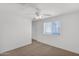 Spacious bedroom with carpet floors, ceiling fan, large window and walk-in closet at 3977 E Cat Balue Dr, Phoenix, AZ 85050