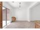Dining area with sliding glass doors and tile flooring, next to kitchen at 3977 E Cat Balue Dr, Phoenix, AZ 85050