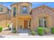 Charming two-story home featuring a stone facade, a covered entryway, and desert landscaping at 3977 E Cat Balue Dr, Phoenix, AZ 85050