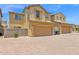 Exterior of home featuring attached two-car garages, brick driveway, and desert landscaping at 3977 E Cat Balue Dr, Phoenix, AZ 85050