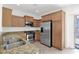 Corner kitchen view featuring stainless steel appliances and granite countertops at 3977 E Cat Balue Dr, Phoenix, AZ 85050