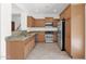 Modern kitchen features stainless steel appliances, granite countertops, and tiled flooring at 3977 E Cat Balue Dr, Phoenix, AZ 85050