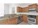 A corner of the kitchen showing stainless appliances, wood cabinetry and granite counters at 3977 E Cat Balue Dr, Phoenix, AZ 85050