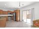 Well-lit kitchen boasts stainless appliances, warm wood cabinets, and tile flooring at 3977 E Cat Balue Dr, Phoenix, AZ 85050