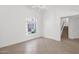 Living room featuring tile floors, an arched window, and stairs to the second level at 3977 E Cat Balue Dr, Phoenix, AZ 85050