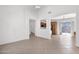 Open-concept living space flows into a kitchen area, with tile floors and natural light at 3977 E Cat Balue Dr, Phoenix, AZ 85050