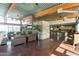 Open lounge features a stone fireplace, modern decor, and exposed beams for a modern, relaxing feel at 3977 E Cat Balue Dr, Phoenix, AZ 85050