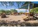 Community playground featuring covered play structures, shade canopies and a sand base at 3977 E Cat Balue Dr, Phoenix, AZ 85050