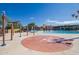 Fun splashpad water feature offers a place for the whole Gathering to enjoy with plenty of lounge seating and a community pool in the background at 3977 E Cat Balue Dr, Phoenix, AZ 85050