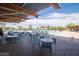 Resort-style pool area with comfortable seating, shaded cabanas, and lush landscaping at 3977 E Cat Balue Dr, Phoenix, AZ 85050