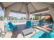 Inviting poolside cabana with comfortable lounge seating, providing a relaxing outdoor retreat at 3977 E Cat Balue Dr, Phoenix, AZ 85050
