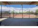 Community tennis courts surrounded by fencing and mature trees for a private and enjoyable experience at 3977 E Cat Balue Dr, Phoenix, AZ 85050