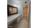 Bathroom featuring marble countertop, white vanity, and large, framed mirror at 4554 E Paradise Village Pkwy # 149, Phoenix, AZ 85032