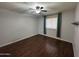 Bedroom with wood flooring, a ceiling fan, and window with curtains at 4554 E Paradise Village Pkwy # 149, Phoenix, AZ 85032