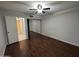 Bedroom features wood flooring, sliding closet doors, and ceiling fan at 4554 E Paradise Village Pkwy # 149, Phoenix, AZ 85032