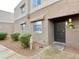 Charming home exterior showcasing a secure entry door and well-maintained landscaping at 4554 E Paradise Village Pkwy # 149, Phoenix, AZ 85032