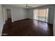 Spacious living room with wood floors and sliding glass doors to the patio at 4554 E Paradise Village Pkwy # 149, Phoenix, AZ 85032