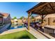 Backyard with pool, gazebo, lounge chairs and artificial turf, perfect for outdoor entertaining at 46065 W Meadows Ln, Maricopa, AZ 85139