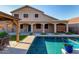 Backyard featuring a beautiful pool, covered patio, and ample room for outdoor entertaining at 46065 W Meadows Ln, Maricopa, AZ 85139