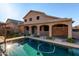 Lush backyard with a sparkling pool, covered patio, and plenty of space for outdoor activities at 46065 W Meadows Ln, Maricopa, AZ 85139