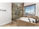 Bathroom featuring a separate tub and shower with tile surround and black hardware at 46065 W Meadows Ln, Maricopa, AZ 85139