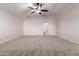 A large bedroom space includes plush carpeting, fan and an en-suite bathroom at 46065 W Meadows Ln, Maricopa, AZ 85139