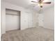 Bedroom with neutral carpet, ceiling fan and a closet with sliding doors at 46065 W Meadows Ln, Maricopa, AZ 85139