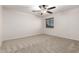 Bedroom features neutral carpet, ceiling fan, and a light-filled window at 46065 W Meadows Ln, Maricopa, AZ 85139