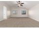 Spacious bedroom with plush carpet, ceiling fan, and vaulted ceilings at 46065 W Meadows Ln, Maricopa, AZ 85139