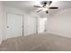 Bedroom with neutral carpet, ceiling fan, and closet with double doors at 46065 W Meadows Ln, Maricopa, AZ 85139