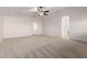A generously sized bedroom featuring neutral carpeting, ceiling fan and adjoining room at 46065 W Meadows Ln, Maricopa, AZ 85139