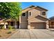 Charming two-story home with a three-car garage and xeriscaped front yard at 46065 W Meadows Ln, Maricopa, AZ 85139