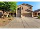 Charming two-story home with a three-car garage and xeriscaped front yard at 46065 W Meadows Ln, Maricopa, AZ 85139
