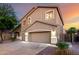 Charming two-story home with a three-car garage, enhanced by landscape lighting at 46065 W Meadows Ln, Maricopa, AZ 85139