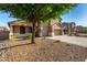 Charming two-story home with a three-car garage and xeriscaped front yard at 46065 W Meadows Ln, Maricopa, AZ 85139
