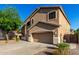 Charming two-story home with a three-car garage and xeriscaped front yard at 46065 W Meadows Ln, Maricopa, AZ 85139