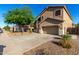 Charming two-story home with a three-car garage and xeriscaped front yard at 46065 W Meadows Ln, Maricopa, AZ 85139