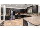 A kitchen with stainless steel appliances, and backsplash and mocha colored counters and cabinets at 46065 W Meadows Ln, Maricopa, AZ 85139