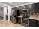 A kitchen with stainless steel appliances and black cabinets at 46065 W Meadows Ln, Maricopa, AZ 85139