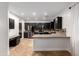 A spacious kitchen with stainless steel appliances, black cabinets and earth tone backsplash at 46065 W Meadows Ln, Maricopa, AZ 85139