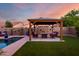 Outdoor living area with a gazebo, patio, and artificial turf makes a backyard oasis at 46065 W Meadows Ln, Maricopa, AZ 85139