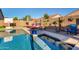 Sparkling pool with poolside basketball hoop, lounge chairs, tropical landscaping, and a serene atmosphere at 46065 W Meadows Ln, Maricopa, AZ 85139