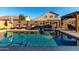 Inviting backyard pool area with ample seating, landscaping, and privacy wall decorations at 46065 W Meadows Ln, Maricopa, AZ 85139