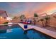 Inviting swimming pool with lounge chairs, basketball hoop, and desert landscaping at 46065 W Meadows Ln, Maricopa, AZ 85139