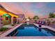 Stunning pool with basketball hoop, lounge chairs and desert landscaping is perfect for entertaining at 46065 W Meadows Ln, Maricopa, AZ 85139
