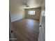 A neutral bedroom showcases wood-look floors, a ceiling fan, and a bright window for natural light at 4701 N 68Th St # 105, Scottsdale, AZ 85251