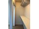 Walk-in closet with painted block walls, wooden floor, and shelving installed at 4701 N 68Th St # 105, Scottsdale, AZ 85251