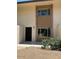 Exterior of the unit with a black door and dual windows with a brick surround at 4701 N 68Th St # 105, Scottsdale, AZ 85251