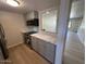 Cozy kitchen featuring stainless steel appliances, gray cabinets, and quartz countertops at 4701 N 68Th St # 105, Scottsdale, AZ 85251
