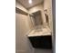 Powder room featuring modern black vanity with marble countertop and a square mirror at 4701 N 68Th St # 105, Scottsdale, AZ 85251